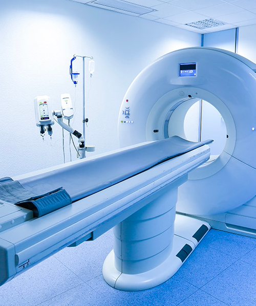 CT-Scanner-In-Calming-White-Room-With-Monitors-In-Background